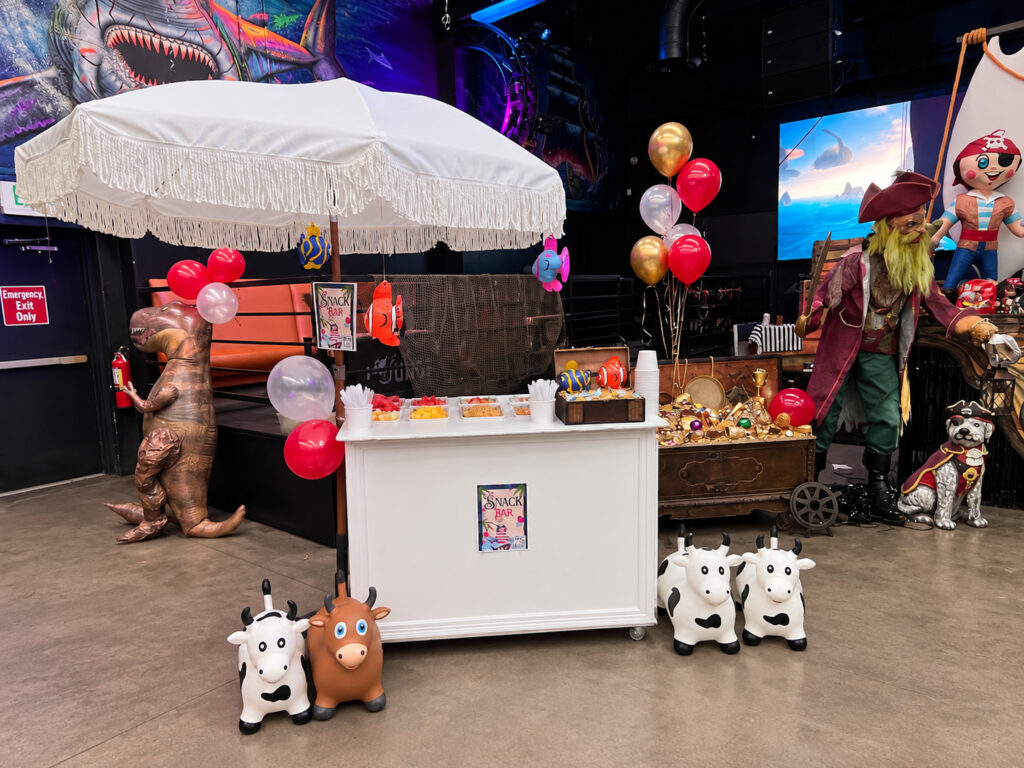 Dino-themed dessert cart setup at a birthday party